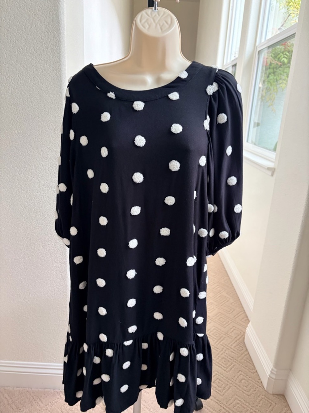 Black and white polka dot Dress w/swing hem, buttons down the back.